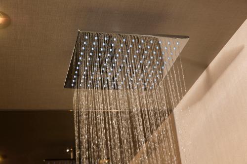a shower with a bunch of water hanging from the ceiling at Bloc Hotel London Gatwick Airport in Horley