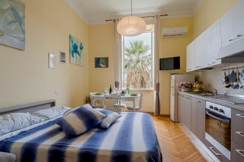 a kitchen with a large bed in a room at Solo a Sanremo in Sanremo