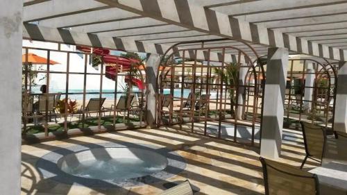 a view of a patio with a pool and chairs at Ap Completo Parq. Aquát. Sensacional Grátis in Caldas Novas
