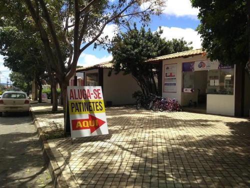 a sign in front of a building that says always store pharmacies at Ap Completo Parq. Aquát. Sensacional Grátis in Caldas Novas