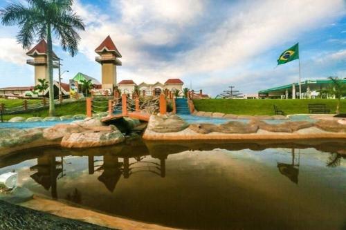 a pool of water in a park with a water slide at Ap Completo Parq. Aquát. Sensacional Grátis in Caldas Novas
