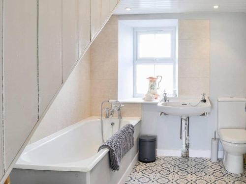 a bathroom with a sink and a tub and a toilet at Blackloch in Gatehouse of Fleet