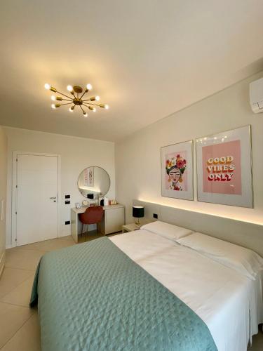 a bedroom with a bed and a ceiling fan at Milena Suite Apartments in Alghero