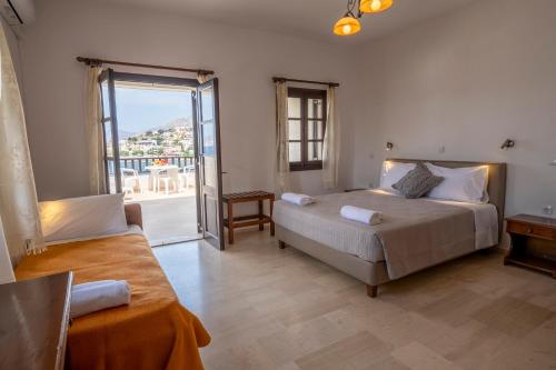 a bedroom with a bed and a window with a view at Pelagos Seafront Accommodation - George in Myrties