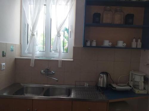 a kitchen with a sink and two windows at THSTUDIOS Its the best in Faraí