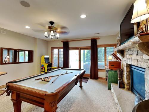 a living room with a pool table and a fireplace at At the Start of It All in McHenry