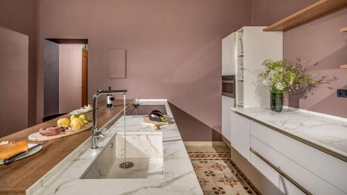 a kitchen with a marble counter top and a sink at VILLA SUMAC 6, Emma Villas in Sortino