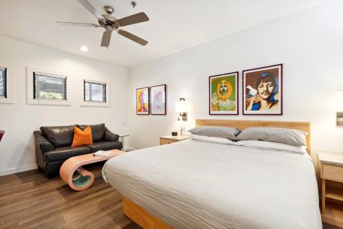 a bedroom with a bed and a couch at Hotel Folly with Marsh and Sunset Views in Folly Beach