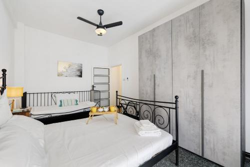 a bedroom with a bed and a ceiling fan at Liguria Home in Vado Ligure