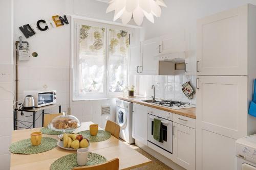 a kitchen with a table with a bowl of fruit on it at Liguria Home in Vado Ligure