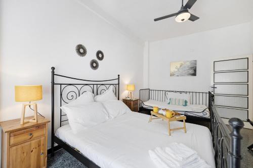 a bedroom with a black and white bed with a fan at Liguria Home in Vado Ligure