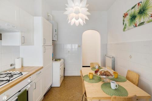 a kitchen with a wooden table and a dining room at Liguria Home in Vado Ligure