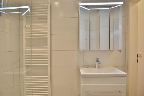 a bathroom with a sink and a mirror at Haus Kastanienallee 3 Haus Kastanienallee 3 Appartement 8 in Timmendorfer Strand