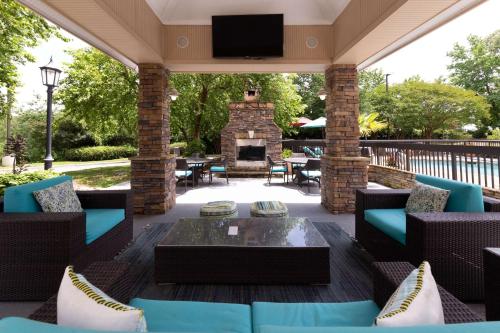 a patio with couches and a fireplace on a deck at Hampton Inn Columbia I-26/Harbison Blvd in Columbia