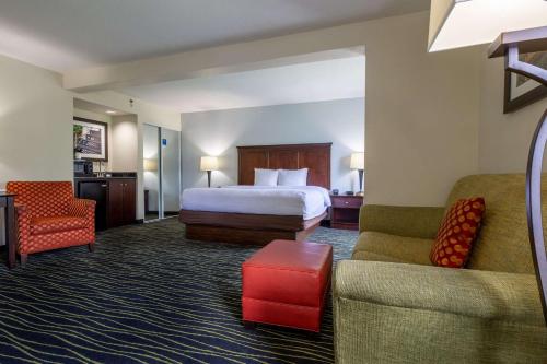 a hotel room with a bed and a couch at Hampton Inn Columbia I-26/Harbison Blvd in Columbia