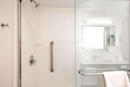 a white bathroom with a glass shower door at Hampton Inn Columbia I-26/Harbison Blvd in Columbia