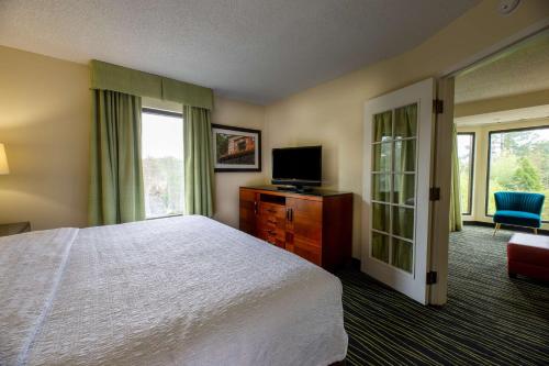 a hotel room with a bed and a television at Hampton Inn Columbia I-26/Harbison Blvd in Columbia