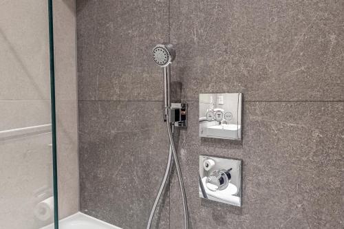 a shower with two sinks in a bathroom at Premier London Apartments Near Camden markets & very close to tube stations by Belvilla in London