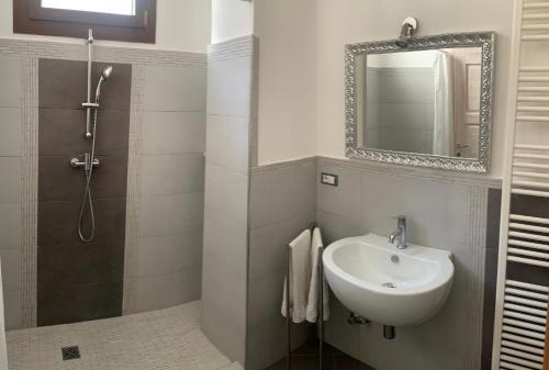 a bathroom with a sink and a mirror at CORTE CARAFA "un'Oasi nel Centro Storico con parcheggio interno riservato" in Nardò
