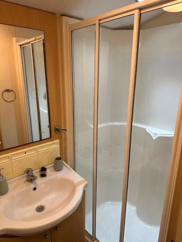 a bathroom with a shower and a sink at Static Caravan - Plymouth - Costal Location in Plymouth