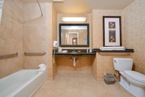 a bathroom with a tub and a toilet and a sink at Hampton Inn and Suites Coeur d'Alene in Coeur d'Alene