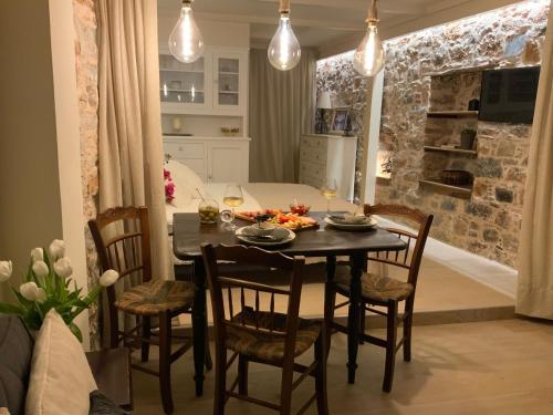 a kitchen and dining room with a table and chairs at Angel's Suites in Samos