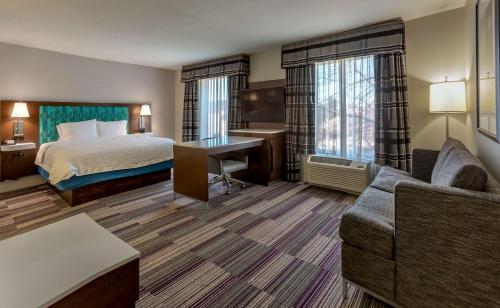 a hotel room with a bed and a desk at Hampton Inn & Suites Chicago Southland-Matteson in Matteson