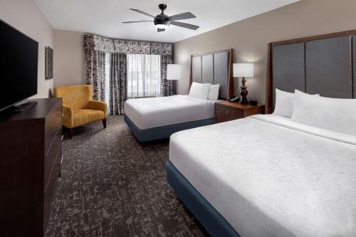 a hotel room with a bed and a television at Homewood Suites by Hilton Orland Park in Orland Park