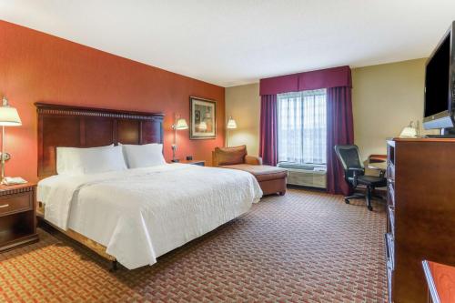 a hotel room with a large bed and a television at Hampton Inn Chattanooga-North in Chattanooga
