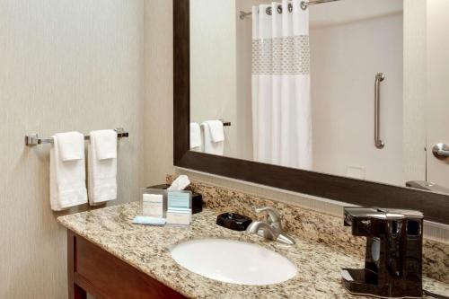 a bathroom with a sink and a large mirror at Hampton Inn Chickasha in Chickasha