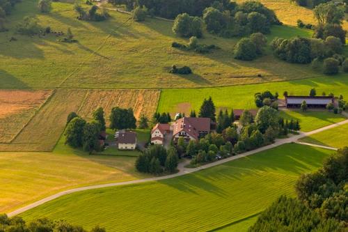 an aerial view of a house on a green field at Stahlecker Hof in Lichtenstein