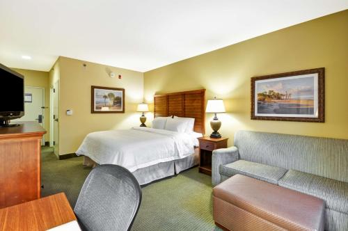 a hotel room with a bed and a couch at Hampton Inn & Suites Charleston/Mt. Pleasant-Isle Of Palms in Charleston