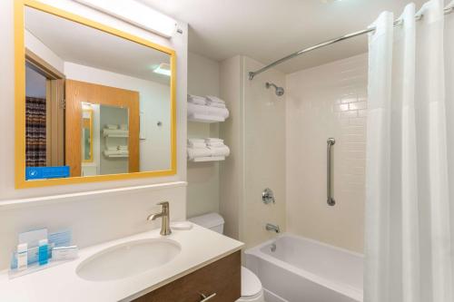 a bathroom with a sink and a toilet and a mirror at Hampton Inn Cedar Rapids in Cedar Rapids