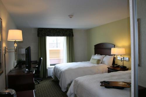 a hotel room with two beds and a window at Hampton Inn & Suites Cleveland-Mentor in Mentor