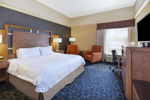 a hotel room with a bed and a desk at Hampton Inn Clinton in Clinton