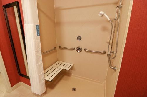 a shower stall with a bench in a bathroom at Hampton Inn Lincolnton in Lincolnton