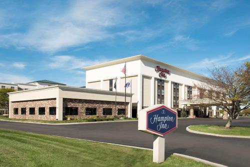 a white building with a sign in front of it at Hampton Inn Columbus/Taylorsville in Edinburgh