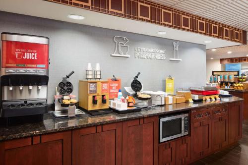 a restaurant kitchen with a counter top with food at Hampton Inn Seymour in Seymour