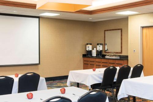 a conference room with tables and chairs and a whiteboard at Hampton Inn Columbus/Taylorsville in Edinburgh