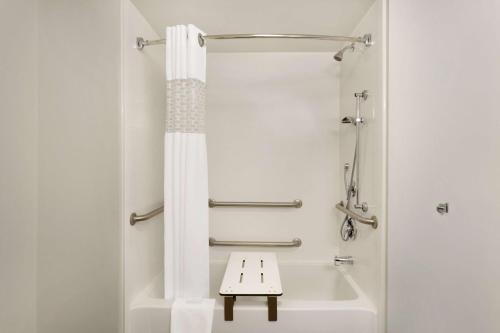 a bathroom with a shower and a bath tub with a shower curtain at Hampton Inn & Suites Largo in Largo