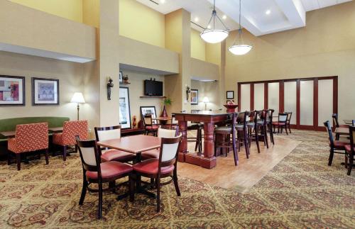 a restaurant with tables and chairs in a room at Hampton Inn & Suites Port Richey in Port Richey