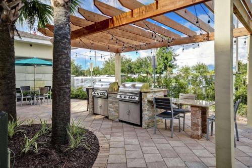 a patio with a grill and a table with chairs at Homewood Suites by Hilton Tampa-Port Richey in Port Richey