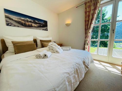 a bedroom with a white bed and a window at Villa Kitzbühel in Kirchberg in Tirol