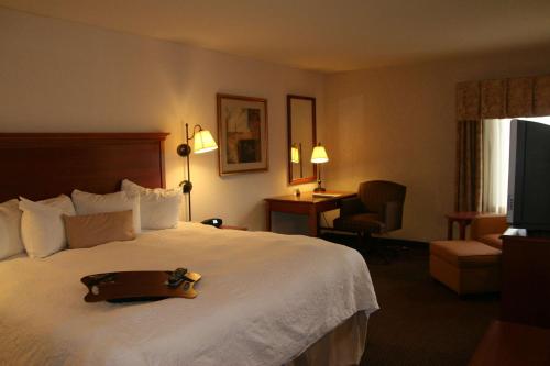 a hotel room with a large bed with a tray on it at Hampton Inn Columbus-International Airport in Gahanna