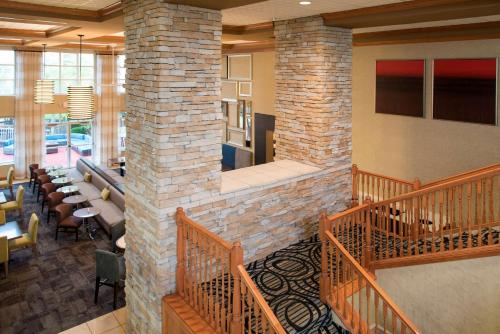 a lobby of a restaurant with tables and chairs at Homewood Suites Columbus - Airport in Columbus