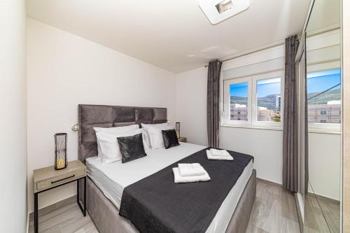 a bedroom with a large bed and a window at Rooftop New Castel 2023 in Kaštela