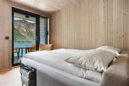 a bedroom with a bed and a table and a window at Wangen Apartments AS in Aurland