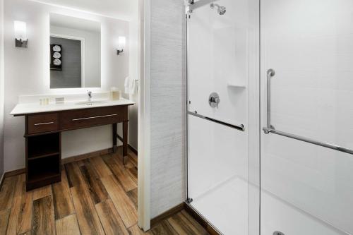 a bathroom with a sink and a shower at Homewood Suites Champaign-Urbana in Champaign