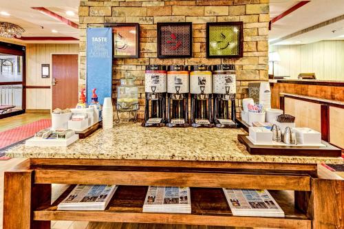 a display of wine bottles on a counter in a store at Hampton Inn Columbus I-70E/Hamilton Road in Columbus