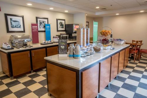 a cafeteria with a counter with food on it at Hampton Inn & Suites Tilton in Tilton